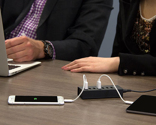 Charging station deployed in a boardroom while charging iPhone and iPad