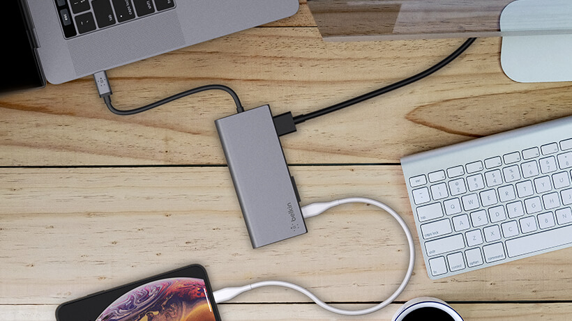 USB-C multiport hub connected to a laptop, monitor, and smartphone simultaneously