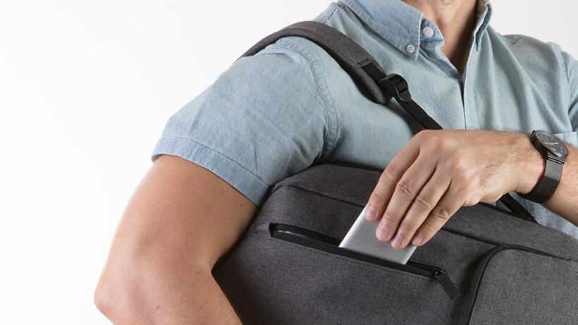 Man putting the Belkin USB-C™ Multimedia Hub into his bag